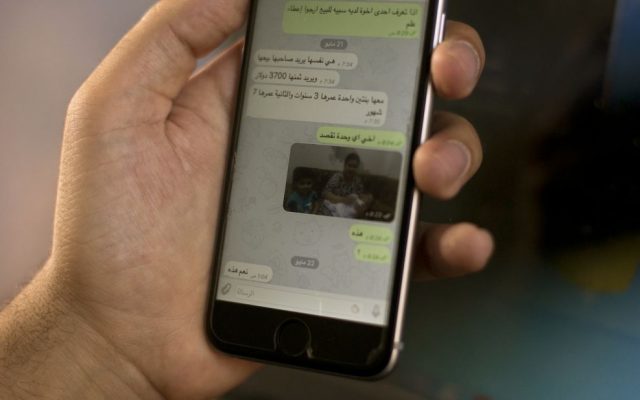On a chat on the WhatsApp app, an Islamic State group militant offers a woman and her children for sale, in this May 22, 2016, photo taken in northern Iraq. "If you know one of the brothers who has a slave for sale, please let me know," it reads in Arabic. "She wants her owner to sell her. He wants a price of $3,700 for her. She has two daughters, one 3 years old, the other 7 months." IS is believed to be holding some 3,000 Yazidi women and girls as sex slaves, and as it loses territory, it has tightened its grip on them to prevent their escape. (AP Photo/Maya Alleruzzo)