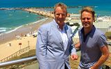 Australian singer Jason Donovan (right) with Hilton hotel marketing manager Motti Verses overlooking the Mediterranean, July 4, 2016 (Courtesy Hilton Hotels)