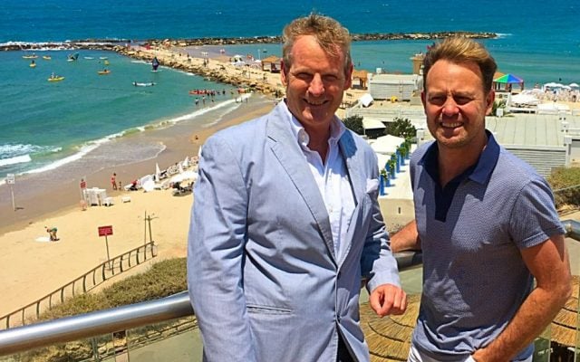Australian singer Jason Donovan (right) with Hilton hotel marketing manager Motti Verses overlooking the Mediterranean, July 4, 2016 (Courtesy Hilton Hotels)