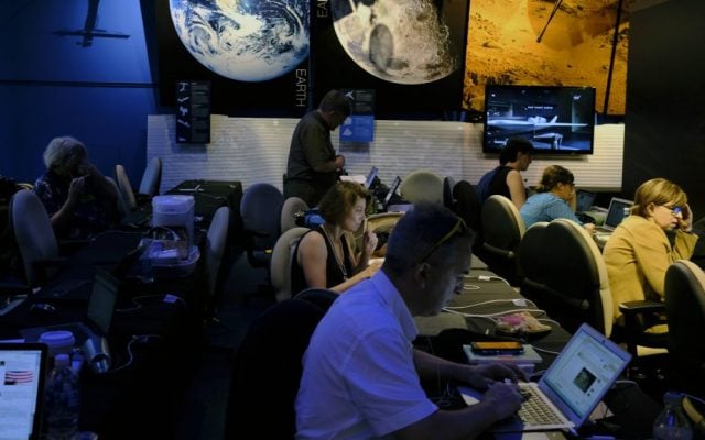 Journalists work in preparation for NASA's Juno spacecraft's orbit around Jupiter in the media center at Jet Propulsion Laboratory, in Pasadena, California, Monday, July 4, 2016. (AP Photo/Richard Vogel) Journalists work in preparation for NASA's Juno spacecraft's orbit around Jupiter in the media center at Jet Propulsion Laboratory, in Pasadena, California, Monday, July 4, 2016. (AP Photo/Richard Vogel)