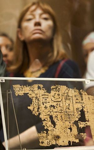 A visitor looks at one of the oldest papyri in the history of Egyptian writing among the collection of King Khufu papyri discovered at Wadi El-Jarf port, as it is on display for the first time at the Egyptian museum in Cairo, Egypt, Thursday, July 14, 2016. (AP/Amr Nabil)