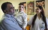 Ahmed Dawabsha, the sole survivor of a West Bank arson attack in Duma village, is carried by his grandfather Hussein at the Tel HaShomer Hospital in Ramat Gan, Israel on Friday, July 22, 2016 (AP Photo/Tsafrir Abayov)