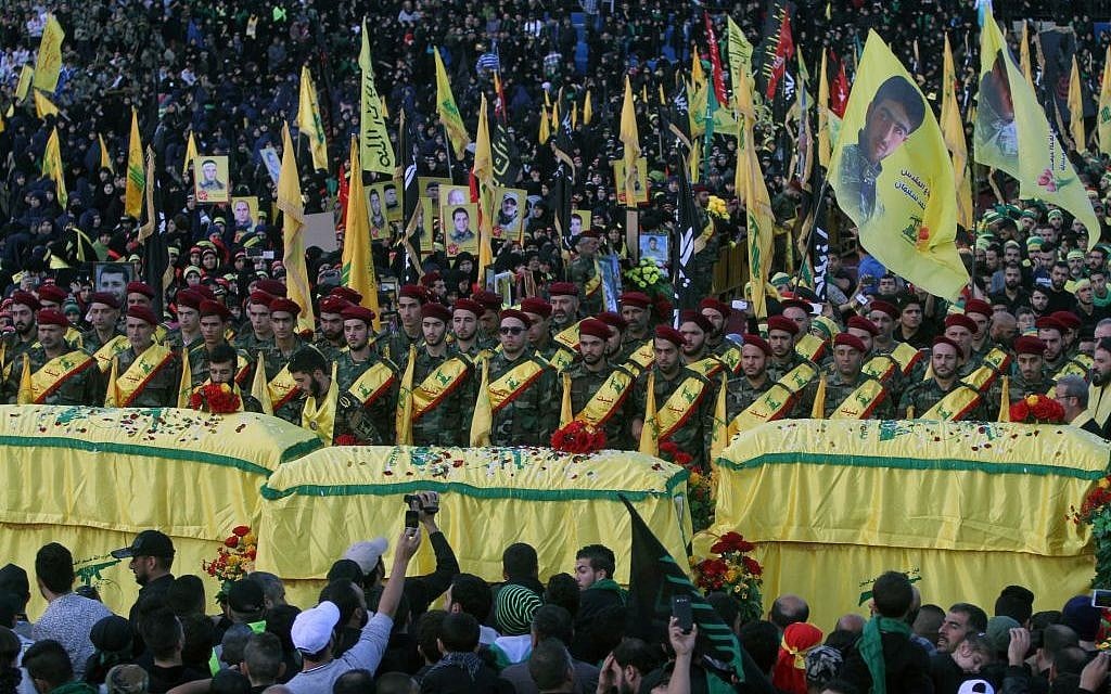 In this Tuesday, Oct. 27, 2015 file photo, relatives and comrades pray as they surround the Hezbollah flag-draped coffins of Shiite fighters who were killed in Syria, during a rally to mark the 13th day of the Shiite mourning period of Muharram, in Nabatiyeh, Lebanon. (AP Photo/Mohammed Zaatari, File) In this Tuesday, Oct. 27, 2015 file photo, relatives and comrades pray as they surround the Hezbollah flag-draped coffins of Shiite fighters who were killed in Syria, during a rally to mark the 13th day of the Shiite mourning period of Muharram, in Nabatiyeh, Lebanon. (AP Photo/Mohammed Zaatari, File)