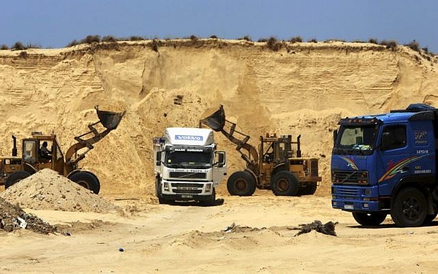 Palestinian diggers dump sand into a truck at the site of Al-Isra 2 housing project in Khan Younis, Gaza Strip, July 20, 2016 (AP Photo/Adel Hana) Palestinian diggers dump sand into a truck at the site of Al-Isra 2 housing project in Khan Younis, Gaza Strip, July 20, 2016 (AP Photo/Adel Hana)