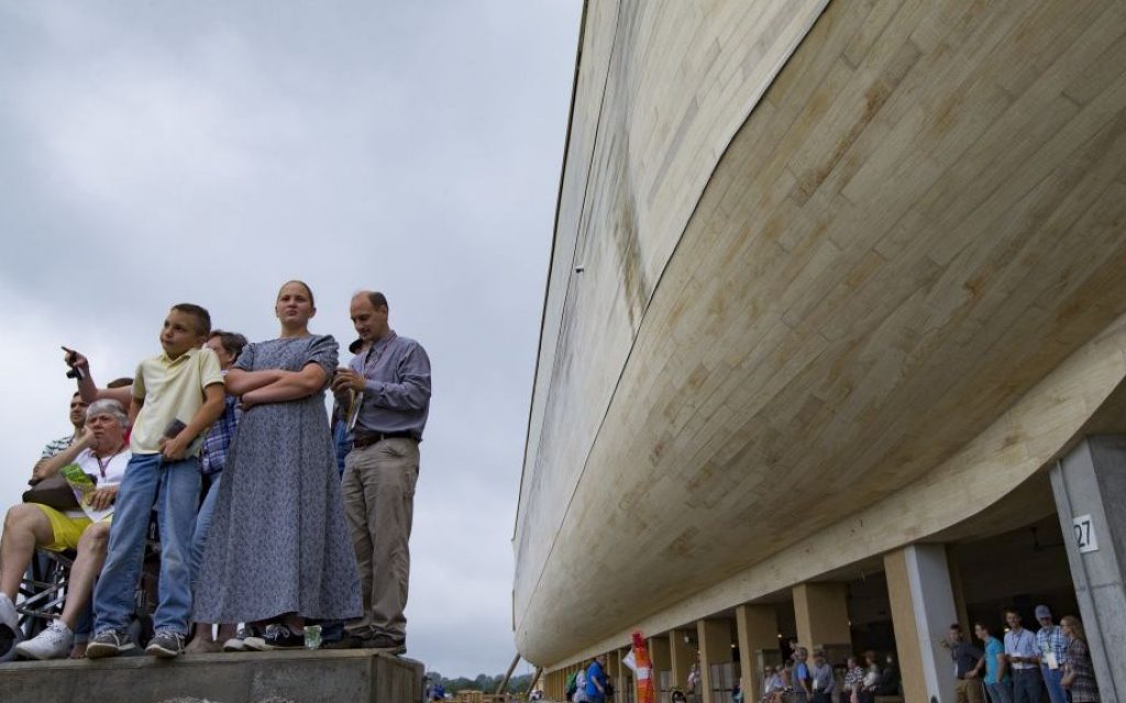 Visitors roam the Ark Encounter theme park as a replica of Noah's Ark stands in the background during a media preview day on July 5, 2016, in Williamstown, Ky. (AP Photo/John Minchillo)