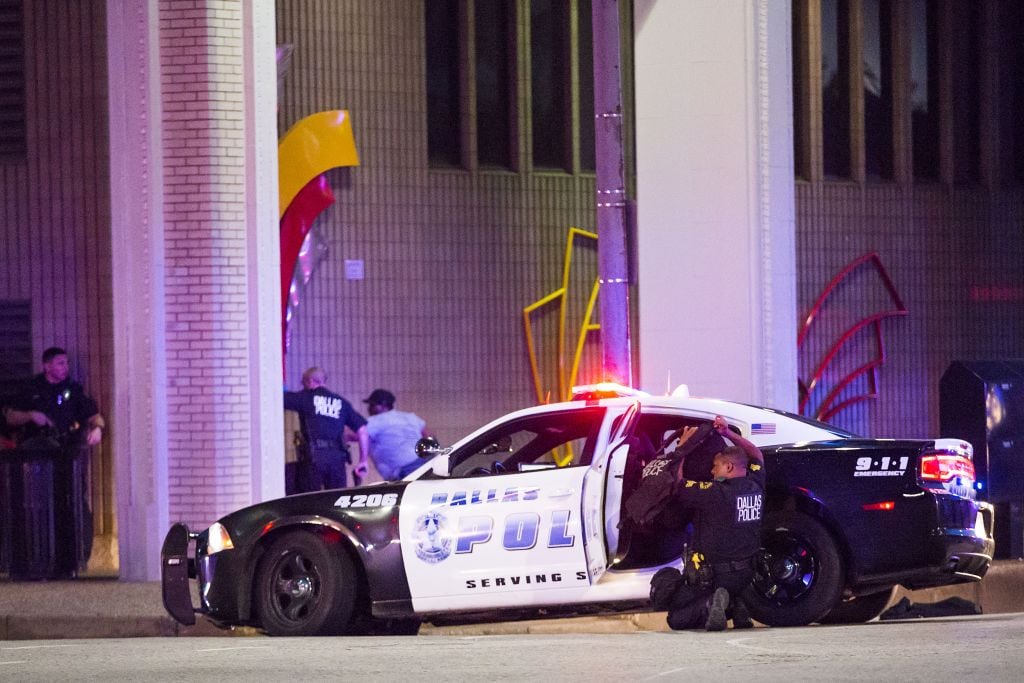 Dallas Police shield bystanders during a Black Live Matter rally in downtown Dallas on Thursday, July 7, 2016. Multiple media outlets report that shots were fired Thursday night during a Dallas protest over two recent fatal police shootings of black men. (Smiley N. Pool/The Dallas Morning News via AP) Dallas Police shield bystanders during a Black Live Matter rally in downtown Dallas on Thursday, July 7, 2016. Multiple media outlets report that shots were fired Thursday night during a Dallas protest over two recent fatal police shootings of black men. (Smiley N. Pool/The Dallas Morning News via AP)