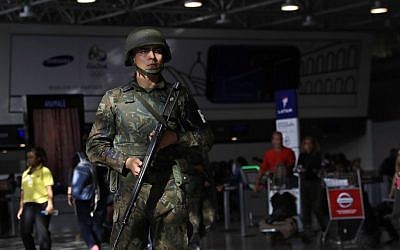 A police officer patrols inside Rio de Janeiro International Airport in Rio de Janeiro, Brazil, Wednesday, July 27, 2016. (AP Photo/Patrick Semansky)