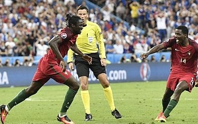 Portugal's Eder, left, celebrates after scoring the opening goal during the Euro 2016 final soccer match between Portugal and France at the Stade de France in Saint-Denis, north of Paris, Sunday, July 10, 2016. (AP /Martin Meissner)