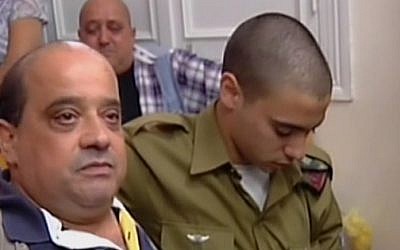 Charlie Azaria, left, with his son Elor Azaria in Jaffa military court on July 5, 2016. (screen capture: Channel 2) Charlie Azaria, left, with his son Elor Azaria in Jaffa military court on July 5, 2016. (screen capture: Channel 2)