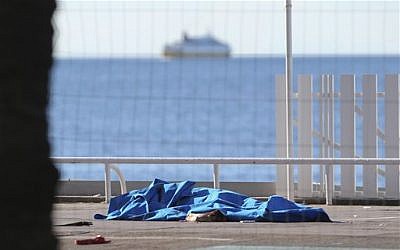 Bodies of victims covered by sheets at the scene of an attack in Nice, southern France, Friday, July 15, 2016, a day after a large truck mowed through revelers gathered for Bastille Day fireworks in Nice, killing at least 84 people as it bore down for more than a mile along the Riviera city's famed waterfront promenade. (AP Photo/Luca Bruno)