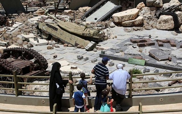 Visitors look at tanks left behind in Lebanon by Israeli forces as they visit the Hezbollah-run 'Tourist Landmark of the Resistance' war museum in Mlita (aka Mleeta) in southern Lebanon on July 12, 2016 (AFP PHOTO / MAHMOUD ZAYYAT)