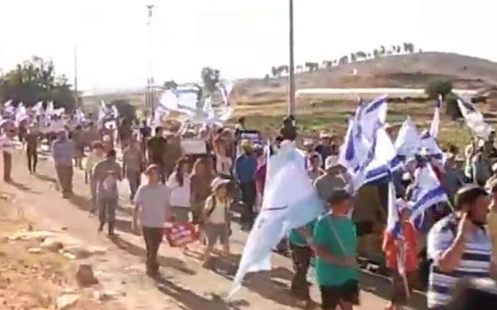 Residents of the Kiryat Arba and Otniel settlements march in protest at the recent violence in the West Bank on July 10, 2016 (screen capture/Channel 2)