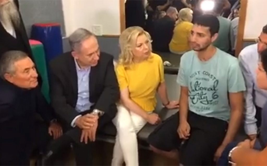 Benjamin and Sara Netanyahu meet with a soldier wounded in the 2014 war at a rehabilitation center in southern Israel on July 28, 2016 (screen capture: Facebook)