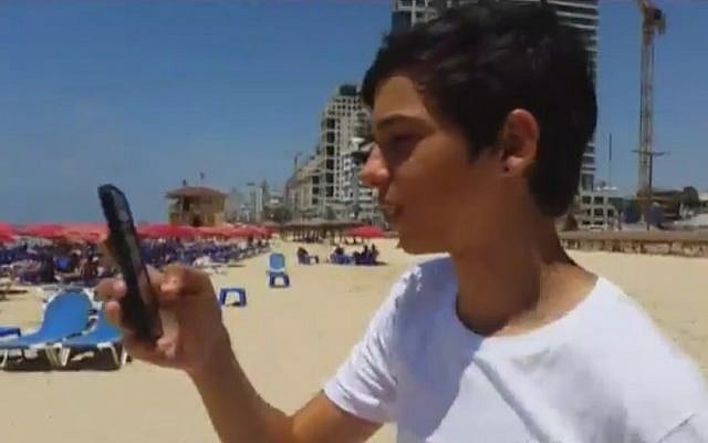 An Israeli teen hunts for Pokemon on the Tel Aviv beachfront (Channel 2 News screen capture) An Israeli teen hunts for Pokemon on the Tel Aviv beachfront (Channel 2 News screen capture)