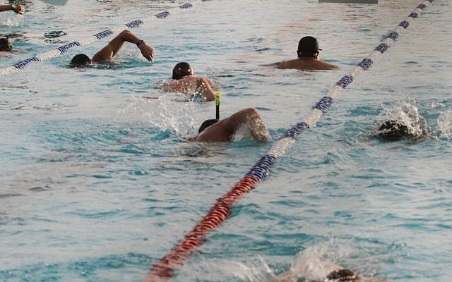 People swimming in a pool in Tel Aviv, on May 15, 2016. (Roni Schutzer/Flash90)