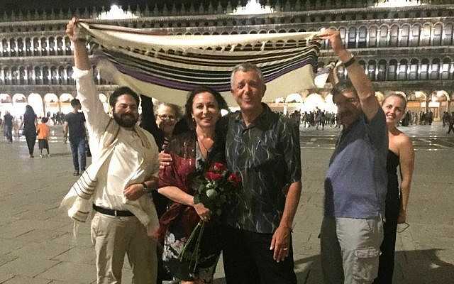 Impromptu Jewish wedding of Americans Lana Atlasov and David Mednick (center) in Venice's Piazza San Marco on June 26, 2016. Todd Shotz (left) officiated. (Courtesy) Impromptu Jewish wedding of Americans Lana Atlasov and David Mednick (center) in Venice's Piazza San Marco on June 26, 2016. Todd Shotz (left) officiated. (Courtesy)