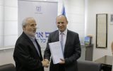 Education Minister Naftali Bennett (right) shakes hands with Israel Prize laureate Erez Biton after receiving a committee's recommendation on increasing Mizrahi education in Israeli schools, on July 7, 2016. (Courtesy: Education Ministry)