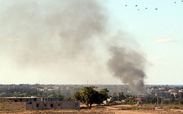 Smoke billows from buildings after the air force from the pro-government forces loyal to Libya's Government of National Unity (GNA) fired rockets targeting Islamic State (IS) group positions in Sirte on July 18, 2016. (AFP PHOTO / MAHMUD TURKIA) Smoke billows from buildings after the air force from the pro-government forces loyal to Libya's Government of National Unity (GNA) fired rockets targeting Islamic State (IS) group positions in Sirte on July 18, 2016. (AFP PHOTO / MAHMUD TURKIA)