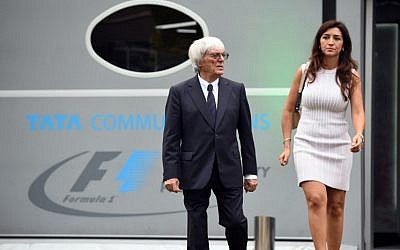 Formula One boss Bernie Eccleston and his wife, Fabiana Flosi in Singapore on September 18, 2014. (AFP PHOTO / TOSHIFUMI KITAMURA).