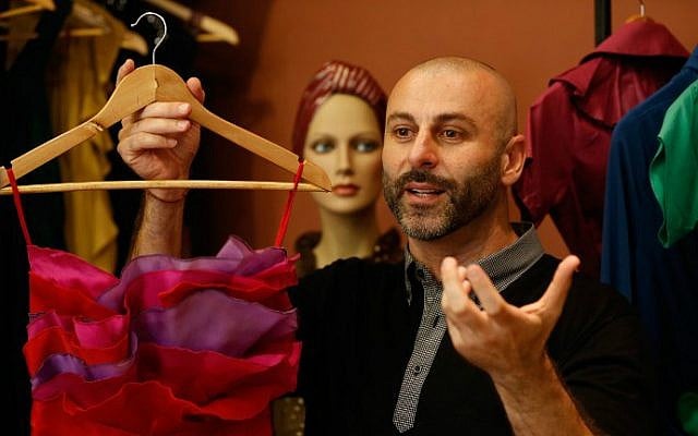 Palestinian American fashion designer Rami Kashou shows one of his designs during a fitting session at a pop-up shop in the West Bank city of Ramallah on July 27, 2016. (Abbas Momani/AFP)