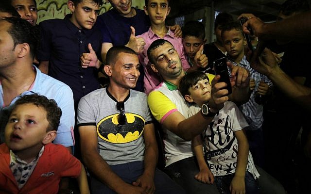Palestinian singer Adel Meshoukhi, center-left, posing for pictures during a wedding in Rafah in the southern Gaza Strip, July 29, 2016. (AFP/SAID KHATIB) Palestinian singer Adel Meshoukhi, center-left, posing for pictures during a wedding in Rafah in the southern Gaza Strip, July 29, 2016. (AFP/SAID KHATIB)
