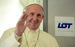 Pope Francis waves during a press conference on the plane after his visit to Krakow for the World Youth Days, on July 31, 2016. (AFP/ POOL / Filippo MONTEFORTE)