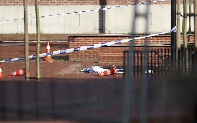 This picture taken on August 6, 2016 shows a blanket on the ground in the area around a police building after a man wounded two policewomen with a machete in the southern Belgian city of Charleroi. AFP/ BELGA / VIRGINIE LEFOUR)