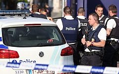 Police stand as they secure the area around a police building in the southern Belgian city of Charleroi following a machete attack on August 6, 2016. (AFP/Belga/Virginie Lefour)