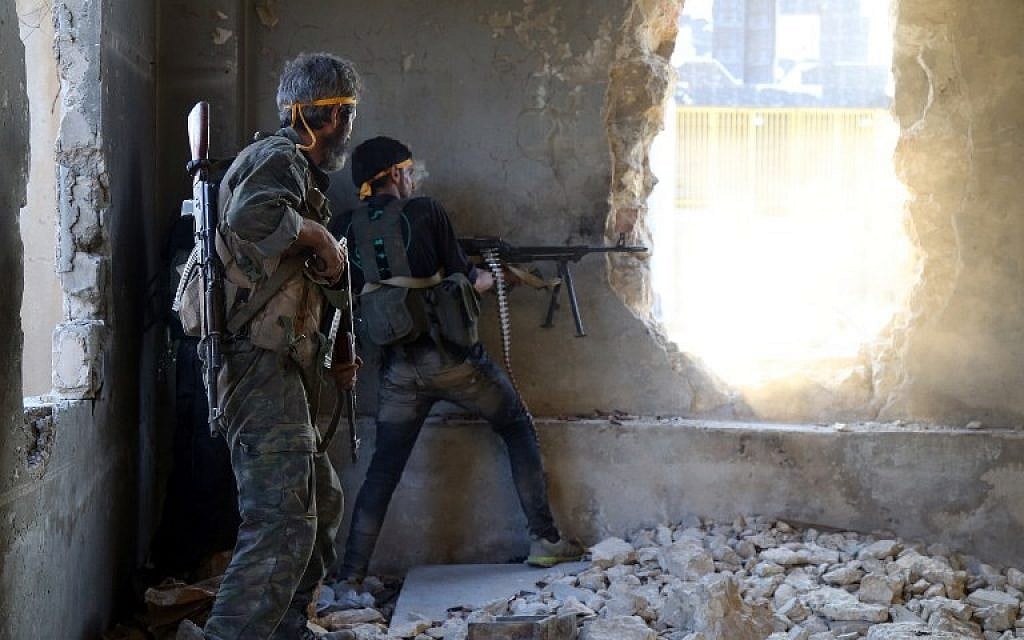 Rebel fighters fire towards positions of regime forces in Ramussa on the southwestern edges of Syria's northern city of Aleppo on August 6, 2016.
Syrian rebels said they have broken a three-week government siege of second city Aleppo, turning the tables on Russian-backed regime forces who are now on the defensive. / AFP PHOTO / FADI AL-HALABI