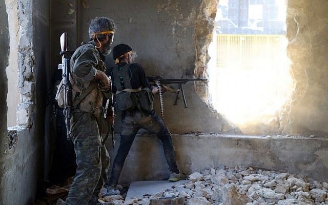 Rebel fighters fire towards positions of regime forces in Ramussa on the southwestern edges of Syria's northern city of Aleppo on August 6, 2016. (AFP/ FADI AL-HALABI)