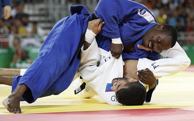 Israel's Golan Pollack (in white) competes with Zambia's Mathews Punza during their men's -66kg judo contest match of the Rio 2016 Olympic Games in Rio de Janeiro on August 7, 2016. (AFP/Jack GUEZ)