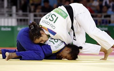 Israel's Gili Cohen (in white) competes with Mauritius' Christianne Legentil, during their women's -52kg judo contest match of the 2016 Olympic Games in Rio de Janeiro, August 7, 2016. (AFP/Jack GUEZ) Israel's Gili Cohen (in white) competes with Mauritius' Christianne Legentil, during their women's -52kg judo contest match of the 2016 Olympic Games in Rio de Janeiro, August 7, 2016. (AFP/Jack GUEZ)