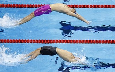 France's Camille Lacourt (top) and Australia's Mitchell Larkin compete in the Men's 100m Backstroke heats during the swimming event at the Rio 2016 Olympic Games at the Olympic Aquatics Stadium in Rio de Janeiro on August 7, 2016. (AFP PHOTO / Odd Andersen)