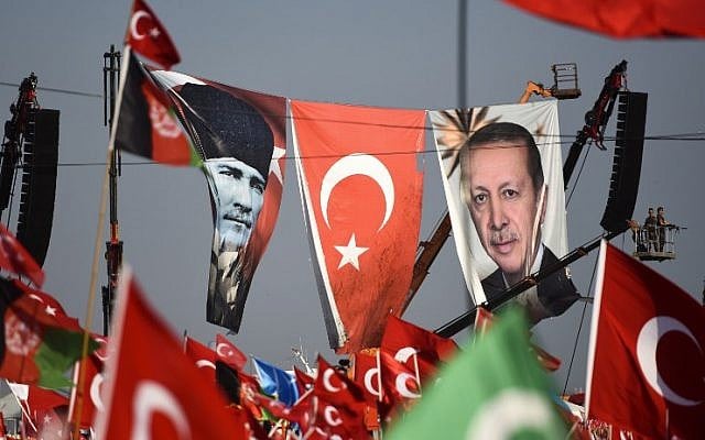 Turkish special force police officers stand guard next to a banner picturing Mustafa Kemal Ataturk, right, and Turkish President Recep Tayyip Erdogan as people wave Turkish national flags during a rally against failed military coup, in Istanbul, August 7, 2016. (AFP/BULENT KILIC) Turkish special force police officers stand guard next to a banner picturing Mustafa Kemal Ataturk, right, and Turkish President Recep Tayyip Erdogan as people wave Turkish national flags during a rally against failed military coup, in Istanbul, August 7, 2016. (AFP/BULENT KILIC)