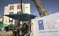 Palestinian construction laborers work on a water well at a Saudi Arabia-funded housing project executed by the United Nations Development Program (UNDP), in Rafah in the southern Gaza Strip, August 9, 2016. (AFP/Said Khatib)