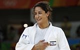Israel's Yarden Gerbi points to the Israeli flag, after defeating Japan's Miku Tashiro to win the bronze medal in the women's under-63kg judo contest, at the Rio 2016 Olympic Games on August 9, 2016. (AFP Photo/Jack Guez)