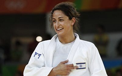 Israel's Yarden Gerbi points to the Israeli flag, after defeating Japan's Miku Tashiro to win the bronze medal in the women's under-63kg judo contest, at the Rio 2016 Olympic Games on August 9, 2016. (AFP Photo/Jack Guez)