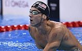 USA's Michael Phelps, showing circular marks from cupping treatment on his skin, as he looks at the results board in the Olympics swimming pool, Rio de Janeiro, August 9, 2016. (AFP/Martin Bureau)