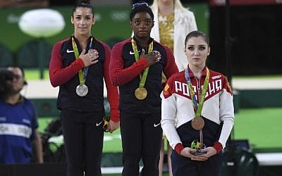 Russia's Aliya Mustafina (right), and Americans Simone Biles (center) and Alexandra Raisman (left) on the podium of the women's individual all-around final of the Artistic Gymnastics during the Olympic Games in Rio de Janeiro, Brazil, on August 11, 2016.
(AFP/Ben Stansall)