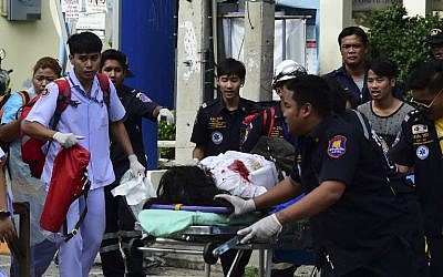 Thai rescue workers attend to an injured victim after a small bomb exploded in Hua Hin on August 12, 2016. (AFP/Munir Uz Zaman)