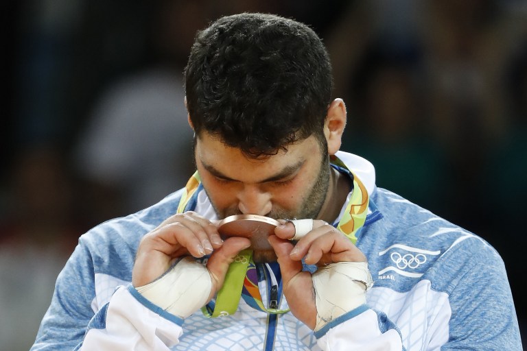 Or Sasson kisses his bronze medal on the podium of the men's +100kg judo contest of the Rio 2016 Olympic Games in Rio de Janeiro on August 12, 2016. (AFP/Jack Guez) Or Sasson kisses his bronze medal on the podium in Rio de Janeiro on August 12, 2016. (AFP/Jack Guez)