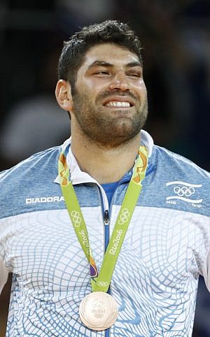 Israeli bronze medalist Or Sasson celebrates on the podium of the men's +100kg judo contest of the Rio 2016 Olympic Games in Rio de Janeiro on August 12, 2016. (AFP PHOTO / Jack GUEZ)