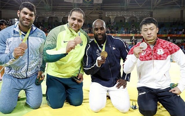 From left: Israel's Or Sasson (bronze), Brazil's Rafael Silva (bronze), France's Teddy Riner (gold), Japan's Hisayoshi Harasawa (silver) celebrate with their medals following the podium ceremony of the men's +100kg judo contest of the Rio 2016 Olympic Games in Rio de Janeiro on August 12, 2016. (AFP PHOTO / Jack GUEZ)