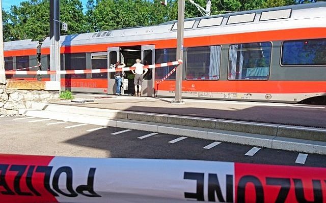Policemen stand by a train at the station in Salez, eastern Switzerland, after a man set a fire and stabbed passengers on August 13, 2016. (AFP PHOTO/NEWSPICTURES.CH/BEAT KAELIN) Policemen stand by a train at the station in Salez, eastern Switzerland, after a man set a fire and stabbed passengers on August 13, 2016. (AFP PHOTO/NEWSPICTURES.CH/BEAT KAELIN)