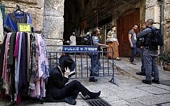 An ultra-Orthodox Jewish man reads Lamentations outside one of the entrances to the Temple Mount, during the annual Tisha B'Av (Ninth of Av) fasting and a memorial day, commemorating the destruction of ancient Jerusalem temples, on August 14, 2016, in Jerusalem's Old City. (AFP PHOTO / AHMAD GHARABLI)