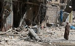 A resident of the Tariq al-Bab neighbourhood of Aleppo, inspects the damage caused by reported air raids that targetted rebel-held areas in the northern city on August 16, 2016.  (AFP PHOTO / THAER MOHAMMED)