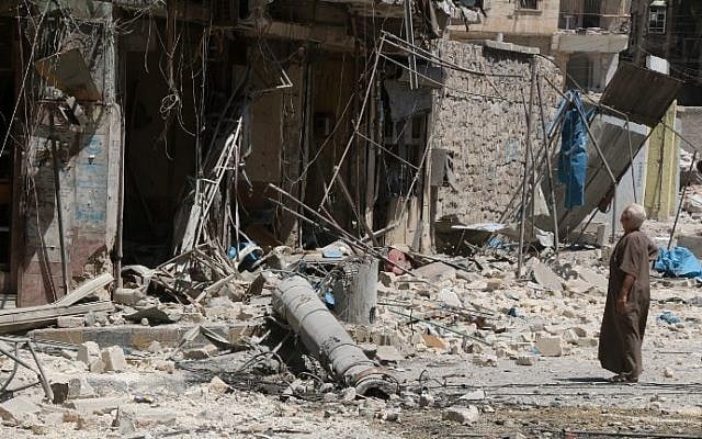 A resident of the Tariq al-Bab neighborhood of Aleppo, inspects the damage caused by reported air raids that targeted rebel-held areas in the northern city on August 16, 2016. (AFP PHOTO / THAER MOHAMMED)