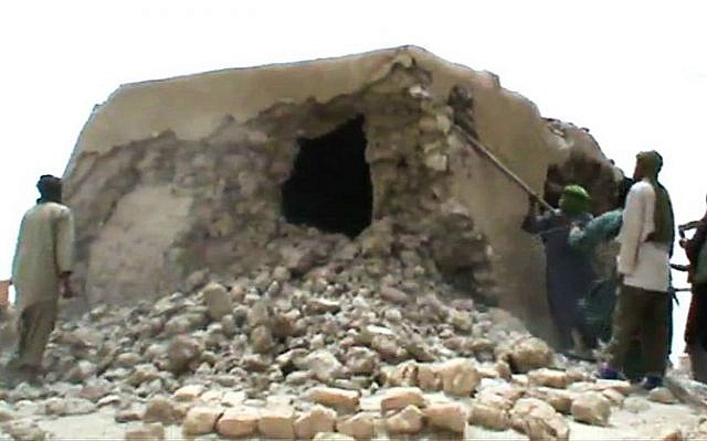 This file image grab photo taken on July 01, 2012 shows Islamist militants destroying an ancient shrine in Timbuktu. (AFP)