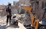 Syrian civil defense volunteers, known as the White Helmets, dig through the debris following an earlier airstrike in the Jallum neighborhood of Aleppo, on August 20, 2016. (AFP/Thaer Mohammed)