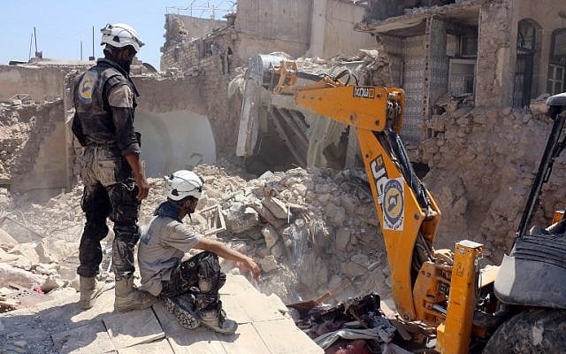 Syrian civil defense volunteers, known as the White Helmets, dig through the debris following an earlier airstrike in the Jallum neighborhood of Aleppo, on August 20, 2016. (AFP/Thaer Mohammed) Syrian civil defense volunteers, known as the White Helmets, dig through the debris following an earlier airstrike in the Jallum neighborhood of Aleppo, on August 20, 2016. (AFP/Thaer Mohammed)